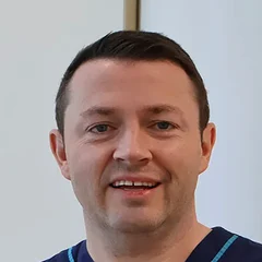 Dr John Loy in Auralia scrubs